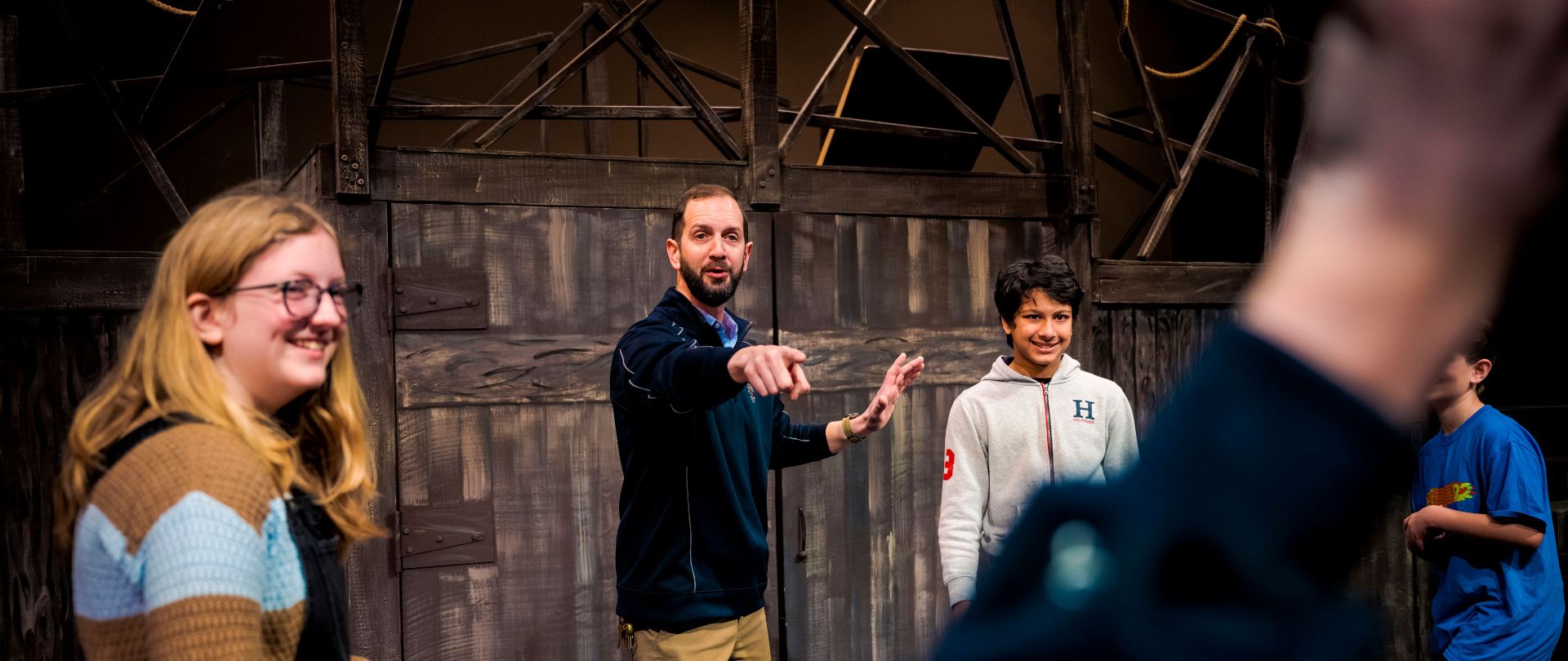 Photo of FA Students and Teacher in a theatre class